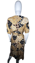 Load image into Gallery viewer, A vintage Norton McNaughton Petites 2-Piece Set with a abstract safari inspired button up short sleeve and skirt. Measured Flat TopChest - 40&quot;Sleeve - 10&quot;Length - 27&quot; Bottom Waist - 30&quot;Hips - 60&quot; Length - 30&quot;
