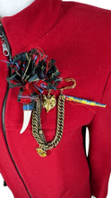 Load image into Gallery viewer, The Vintage KronHaus Coat is a luxurious, bespoke red wool coat. Its unique vintage charm is further enhanced by subtle imperfections near the button zipper area, as shown in the picture. The chest measures 39 inches when laid flat, and the sleeves are...