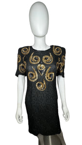 A Vintage Sho-Girl Design 100% pure silk black and gold sequin and beaded dress that zips in the back. Measured FlatChest - 28"Waist - 30"Hips - 34"Length - 40"