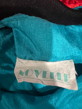 Load image into Gallery viewer, Get ready to add some retro flair to your wardrobe with this Vintage Novelle 80s Teal Blouse! Featuring a stretch waist band and shoulder pads, this blouse will give you a bold and unique look. When laid flat, it measures 42&quot; at the chest and has a len...