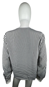 This Vintage Notations blouse features classic black and white pin stripes, perfect for adding a touch of retro charm to any outfit. Though it may be missing one button, the chest measures at a flattering 32 inches and the sleeves at a stylish 22 inche...