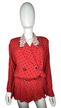 Load image into Gallery viewer, This large vintage Carole Little blazer rocks a bold red color, featuring a peplum bottom, a flowery collar, and charming decorative buttons. When flattened, it measures 42&quot; around the chest, with 22&quot; sleeves, a 26&quot; waist, and a 29&quot; length.