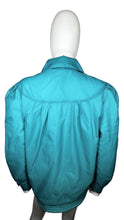 Load image into Gallery viewer, This vintage windbreaker jacket in medium size features a striking teal color and exaggerated shoulders, reminiscent of the bold styles from the 80&#39;s and 90&#39;s. The measurement details are as follows: chest - 41 inches, sleeve - 24 inches, and length -...