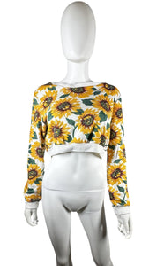 Bask in the sun with our 36 Point 5 Sunflower Sweatshirt. This cropped sweatshirt features a playful and quirky all-over sunflower print. Measured flat at 31" chest, 24 1/2" sleeves, and 16 1/2" length. Perfect for adding a touch of fun to any outfit!