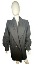 Load image into Gallery viewer, This pristine vintage Donny Brook peacoat is made of rare heavy black wool, featuring magnificent lion head bronze buttons. Measuring at 46 inches across the chest, with 25-inch sleeves and a length of 40 inches, it is a true gem.