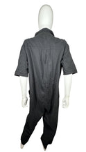 Load image into Gallery viewer, Expertly designed for style and functionality, this Divided jumpsuit is available in a sleek black color and features convenient cargo chest pockets, pant pockets, and belt loops. The precise measurements of this jumpsuit are as follows: Chest - 52&quot;, S...