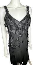 Load image into Gallery viewer, Get ready to turn heads in this sleek R&amp;M Richards formal dress, adorned with intricate black leaf designs. The measurements speak for themselves: 34&quot; flat chest, 28&quot; waist, 35&quot; hips, and a stunning 55&quot; length.