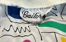 Load image into Gallery viewer, This Vintage Gailord 80&#39;s top boasts colorful sheer material and playful shapes all over. Measured flat, it has a chest of 36&quot;, sleeves of 25&quot;, and a length of 21&quot;.