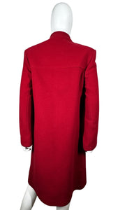 The Vintage KronHaus Coat is a luxurious, bespoke red wool coat. Its unique vintage charm is further enhanced by subtle imperfections near the button zipper area, as shown in the picture. The chest measures 39 inches when laid flat, and the sleeves are...