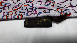 Add a touch of luxury to any outfit with this authentic Louis Vuitton floral silk scarf. The beautiful design and signature gold tie ring make it a versatile accessory for any occasion. Upgrade your style with a touch of French elegance!