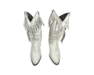 These ACME cowgirl boots from the 80's are a unique find, with their white color and fringes. While the size is unknown, the boot length measures 10 inches, which typically translates to a size 8 or 9. Since they're vintage, they may run a bit smaller...
