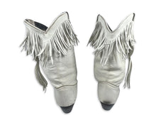 Load image into Gallery viewer, These ACME cowgirl boots from the 80&#39;s are a unique find, with their white color and fringes. While the size is unknown, the boot length measures 10 inches, which typically translates to a size 8 or 9. Since they&#39;re vintage, they may run a bit smaller...