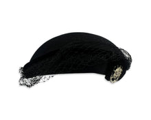 Load image into Gallery viewer, This pillbox hat is a vintage gem, featuring a black velvet design and adorned with a silver and rhinestone brooch. It&#39;s Union made and comes in its original box.