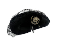 Load image into Gallery viewer, This pillbox hat is a vintage gem, featuring a black velvet design and adorned with a silver and rhinestone brooch. It&#39;s Union made and comes in its original box.