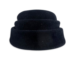 This fab 50's Pillbox Black Hat boasts a luxurious velvet and wool construction, topped off with a dazzling gold and rhinestone brooch. Measuring 8" in diameter, it's a stylish nod to the vintage era.