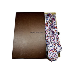 Add a touch of luxury to any outfit with this authentic Louis Vuitton floral silk scarf. The beautiful design and signature gold tie ring make it a versatile accessory for any occasion. Upgrade your style with a touch of French elegance!