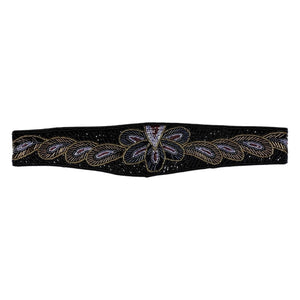 This waist belt is the perfect combo of vintage chic and playful fun! Featuring a black, hand-beaded design with a gleaming iridescent and gold floral pattern, it measures a cool 31 1/2 inches and attaches with a convenient Velcro assembly.