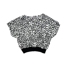 Load image into Gallery viewer, A vintage black and white all over floral print shirt by Rhoda Lee. Measured Flat Chest - 48&quot; Waist - 44&quot; Length - 22&quot;