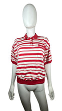 Load image into Gallery viewer, Experience classic style with this Vintage Karen Scott polo featuring red and white stripes and a convenient cigarette pocket. Its flattering fit measures 44&quot; in the chest, with 8&quot; sleeves and a length of 21 1/2&quot;.&nbsp;  &nbsp;