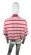 Load image into Gallery viewer, Experience classic style with this Vintage Karen Scott polo featuring red and white stripes and a convenient cigarette pocket. Its flattering fit measures 44&quot; in the chest, with 8&quot; sleeves and a length of 21 1/2&quot;.&nbsp;  &nbsp;