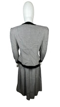 Load image into Gallery viewer, This posh Vintage Jessica Howard by Mitchell Rodbell suit features a charming houndstooth blazer with shoulder pads and a matching skirt. Measurements when laid out flat include 32&quot; for the top chest and 21&quot; for the sleeves, with a length of 23&quot;. The bottom waist measures 26&quot; and the hips are a generous 44&quot; with a length of 31&quot;.