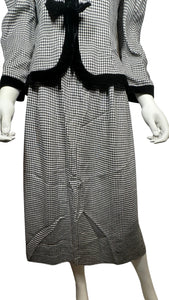 This posh Vintage Jessica Howard by Mitchell Rodbell suit features a charming houndstooth blazer with shoulder pads and a matching skirt. Measurements when laid out flat include 32" for the top chest and 21" for the sleeves, with a length of 23". The bottom waist measures 26" and the hips are a generous 44" with a length of 31".