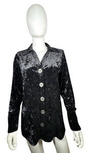 This vintage Harve Benard by Senard Holtzman Button Up features a sleek black crushed velvet material, creating a cozy cardigan style with a touch of glamour. Measured flat, its chest is a perfect 38 inches and its sleeves extend to 23 inches, while it...