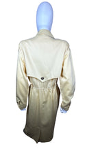 Load image into Gallery viewer, This vintage yellow trench dress can do double duty as both a dress and an open trench coat. One of the buttons is currently M.I.A. at the very bottom, but it&#39;s still a standout piece. When lying flat, it measures 22 inches for the sleeve, 32 inches fo...