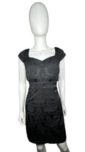 Load image into Gallery viewer, Black cocktail dress with cap sleeves, filagree pattern and cut outs on the sides. Measured Flat Chest - 34&quot; Waist - 30&quot; Hips - 34&quot; Length - 35 1/2&quot;