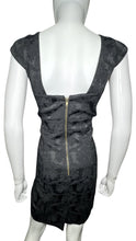 Load image into Gallery viewer, Black cocktail dress with cap sleeves, filagree pattern and cut outs on the sides. Measured Flat Chest - 34&quot; Waist - 30&quot; Hips - 34&quot; Length - 35 1/2&quot;