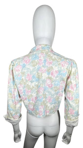Pastel floral print crop jacket. Its a vintage size 10 so it runs smaller. Measured Flat Chest - 36" Sleeve - 16 1/2" Length - 17"