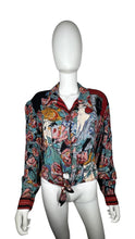Load image into Gallery viewer, This Vintage Carole Little blouse is adorned with charming rose buttons and features a playful tie front. Measurements include a 34&quot; chest, 23&quot; sleeves, and a length of 19 1/2&quot;.