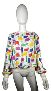 This Vintage Gailord 80's top boasts colorful sheer material and playful shapes all over. Measured flat, it has a chest of 36", sleeves of 25", and a length of 21".