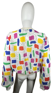 This Vintage Gailord 80's top boasts colorful sheer material and playful shapes all over. Measured flat, it has a chest of 36", sleeves of 25", and a length of 21".