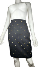 Load image into Gallery viewer, This is a Vintage Outlander Collection Skirt from the 80&#39;s thats a high waisted black skirt with metal gold studs all over that zips in the back. Measured Flat Waist - 28&quot; Hips - 36&quot; Length - 21&quot;