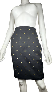 This is a Vintage Outlander Collection Skirt from the 80's thats a high waisted black skirt with metal gold studs all over that zips in the back. Measured Flat Waist - 28" Hips - 36" Length - 21"