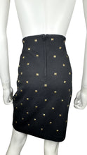 Load image into Gallery viewer, This is a Vintage Outlander Collection Skirt from the 80&#39;s thats a high waisted black skirt with metal gold studs all over that zips in the back. Measured Flat Waist - 28&quot; Hips - 36&quot; Length - 21&quot;