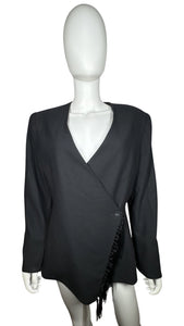 Experience the timeless allure of our Vintage Blazer with tassels. Wrap yourself in elegance and grace with its buttoned closure and intricate button detailing on the sleeves. Please note that this garment has a delicate light stain on the front. Measu...