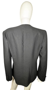 Experience the timeless allure of our Vintage Blazer with tassels. Wrap yourself in elegance and grace with its buttoned closure and intricate button detailing on the sleeves. Please note that this garment has a delicate light stain on the front. Measu...