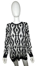 Load image into Gallery viewer, Experience the versatility of our black and white patterned geometric sweater - wear it as a dress with tights underneath or pair it with your favorite bottoms for a stylish look! Measured Flat Chest -36&quot; Sleeve -22&quot; Length -30&quot;