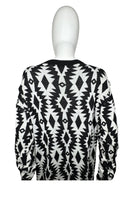Load image into Gallery viewer, Experience the versatility of our black and white patterned geometric sweater - wear it as a dress with tights underneath or pair it with your favorite bottoms for a stylish look! Measured Flat Chest -36&quot; Sleeve -22&quot; Length -30&quot;