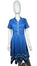 Load image into Gallery viewer, Embrace your retro side with this playful 50&#39;s-inspired blue dress, featuring a silhouette that flatters every figure. Measuring at a flat chest of 34 inches, 8-inch sleeves, a 30-inch waist, and a 41-inch length, this dress is perfect for adding some...