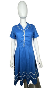 Embrace your retro side with this playful 50's-inspired blue dress, featuring a silhouette that flatters every figure. Measuring at a flat chest of 34 inches, 8-inch sleeves, a 30-inch waist, and a 41-inch length, this dress is perfect for adding some...