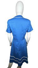 Load image into Gallery viewer, Embrace your retro side with this playful 50&#39;s-inspired blue dress, featuring a silhouette that flatters every figure. Measuring at a flat chest of 34 inches, 8-inch sleeves, a 30-inch waist, and a 41-inch length, this dress is perfect for adding some...