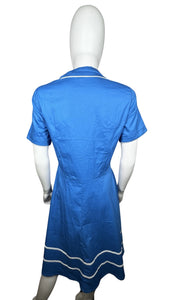 Embrace your retro side with this playful 50's-inspired blue dress, featuring a silhouette that flatters every figure. Measuring at a flat chest of 34 inches, 8-inch sleeves, a 30-inch waist, and a 41-inch length, this dress is perfect for adding some...