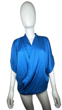 Load image into Gallery viewer, Experience luxury in this excellent condition blue silk blouse from Designer Diane Von Furstenberg. With its kimono-style drape and waist elastic stretch band, it&#39;s perfect for sizes small-medium.