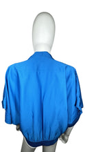 Load image into Gallery viewer, Experience luxury in this excellent condition blue silk blouse from Designer Diane Von Furstenberg. With its kimono-style drape and waist elastic stretch band, it&#39;s perfect for sizes small-medium.