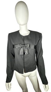 Introducing the Vintage Leslie Fay Black Crop Blazer - the perfect combination of chic and playful! This blazer features a front button closure, satin bow detail, and shoulder pads, along with measurements of 35" chest, 22" sleeves, and 21" length when...