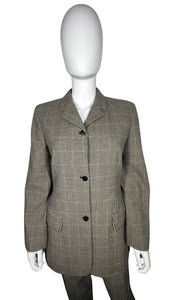 A unique throwback Liz Claiborne collection featuring a luxurious wool tweed suit adorned with houndstooth pattern. This suit comes with a blazer and pants set, with measurements of blazer chest at 30 inches, sleeve at 23 inches, and length at 29.5 inc...