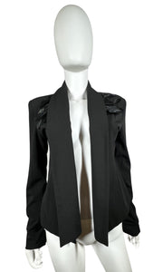 This Designer Madison Marcus Blazer comes in classic black and features feathers. When laid flat, it measures 32" from chest to chest and has a sleeve length of 25 1/2". With a front length of 26" and back length of 21", it's the perfect combination of...